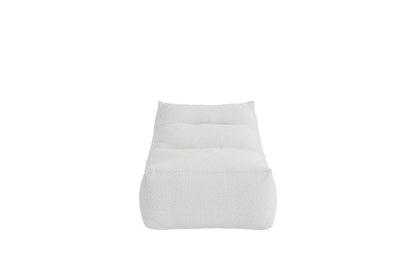 Minimalist white cushioned lounge chair featuring a tufted design and soft textured fabric, ideal for modern living spaces and relaxation. | PicSEO 1773145271301